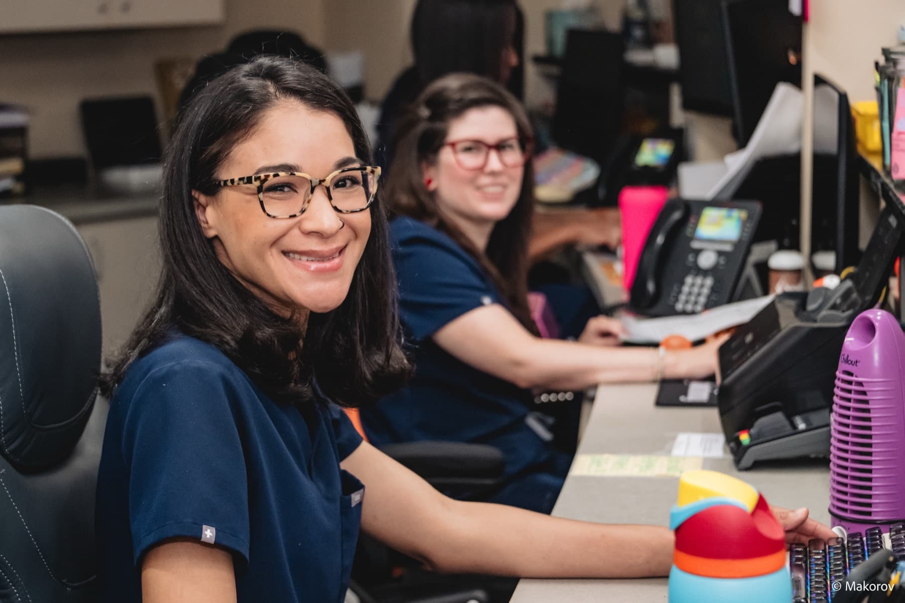 Smiling Landmark Smiles team members at the front desk