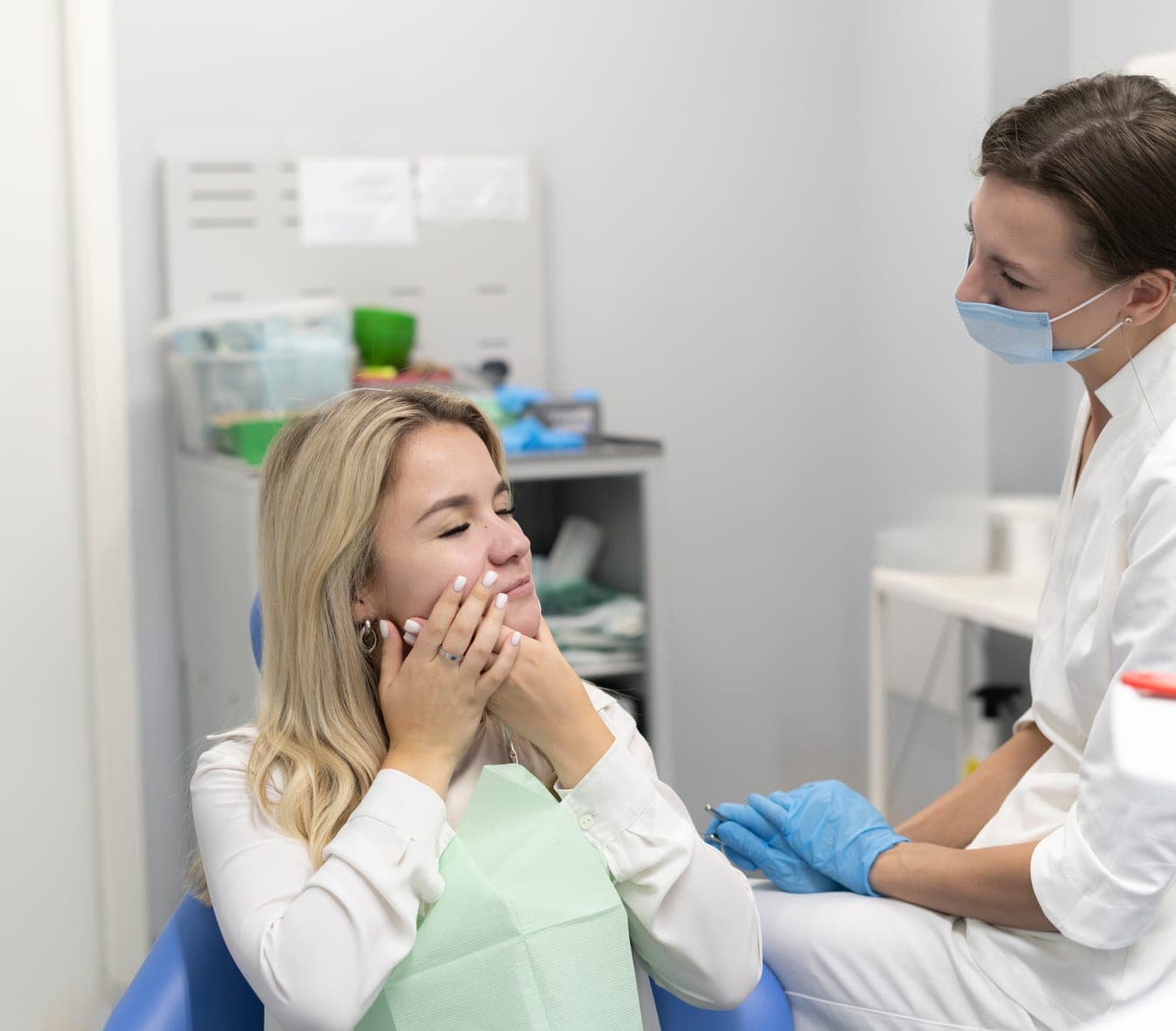 Patient with a toothache talking with her dentist