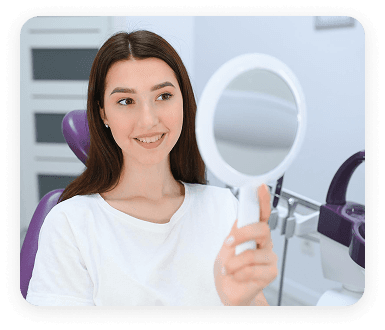 Patient checking her smile in a mirror
