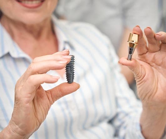 Patient holding a dental implant and crown