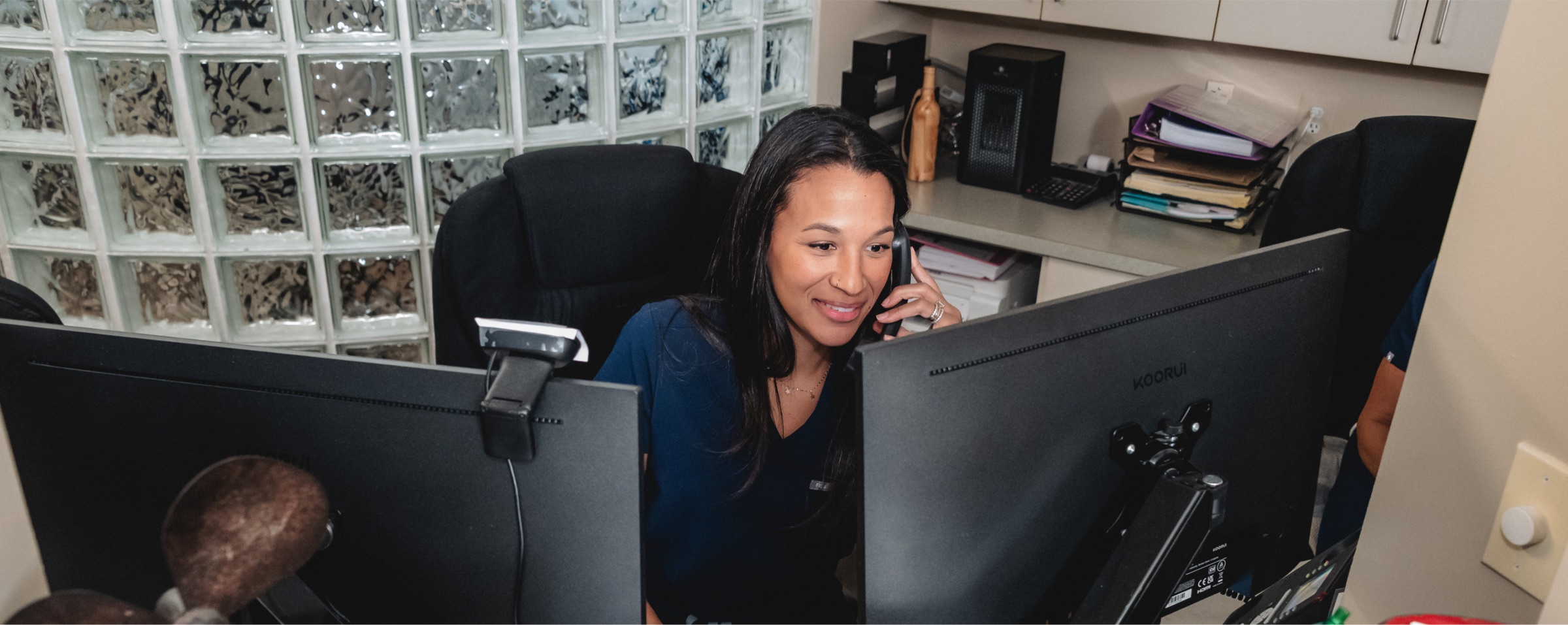 Landmark Smiles front desk team member on the phone