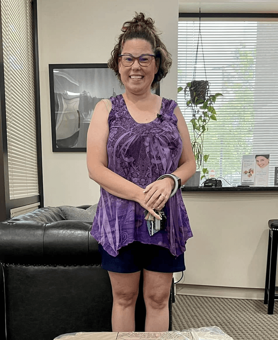 Happy patient standing in the Landmark Smiles office