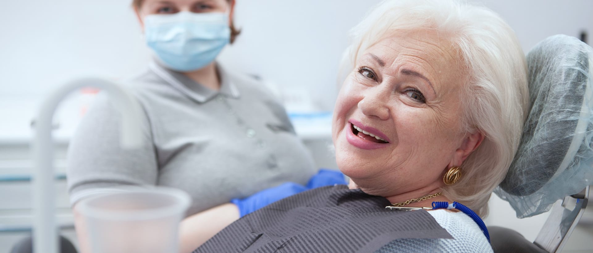Smiling senior patient in the dental chair