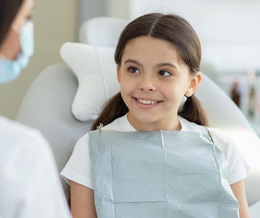 Smiling girl in the dental chair